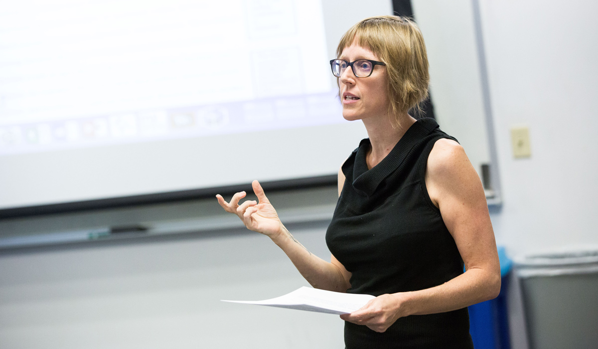 An English teacher speaking to her class during her lesson.
