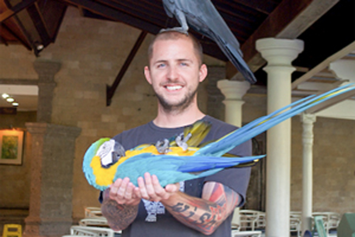 ASU Online student, Chance Hope, with exotic birds.