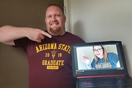 ASU Brand Ambassador, Drew McDowell, pointing at his laptop.