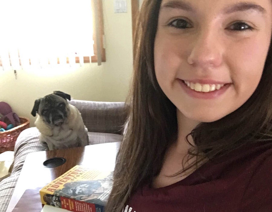 An ASU student takes a selfie with her dog while at home.