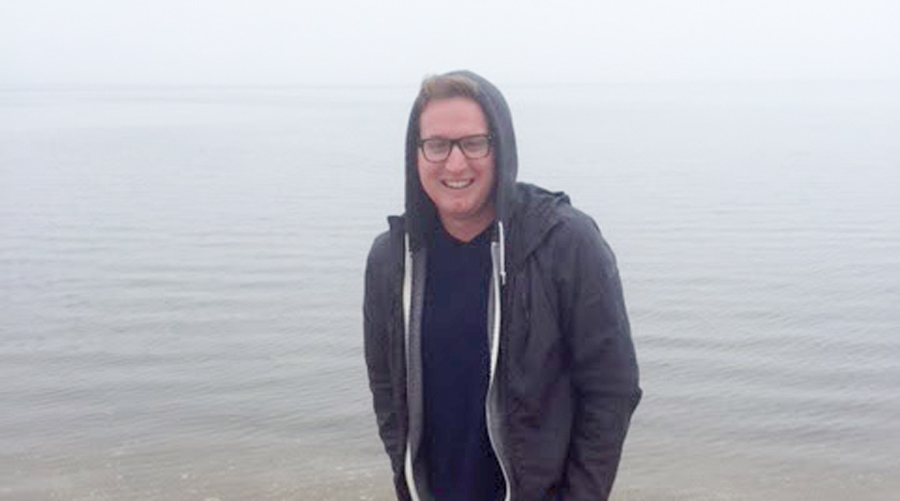 Kevin Hahn standing in the water at the beach