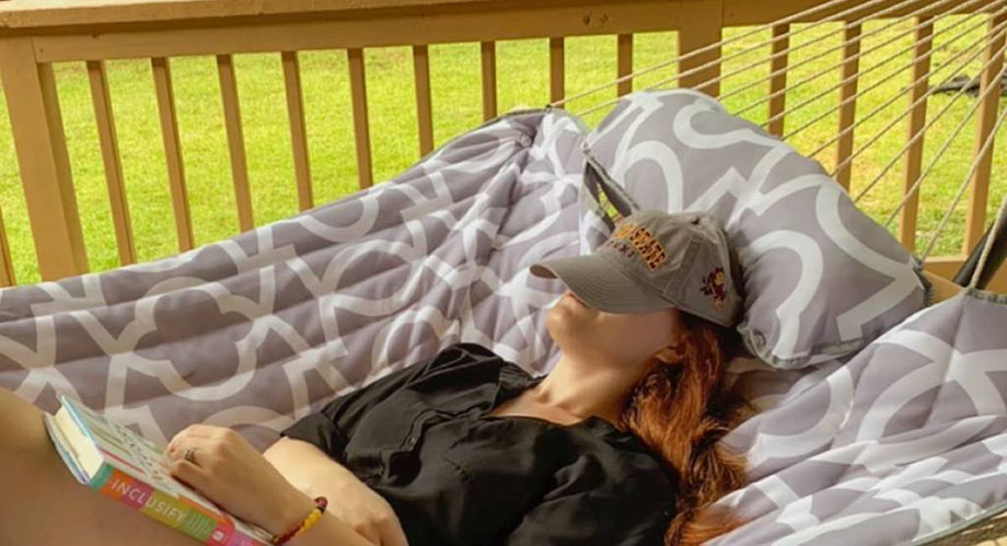 ASU Online student and brand ambassador Lauren Dohr recharging with a relaxing reading session in her hammock.