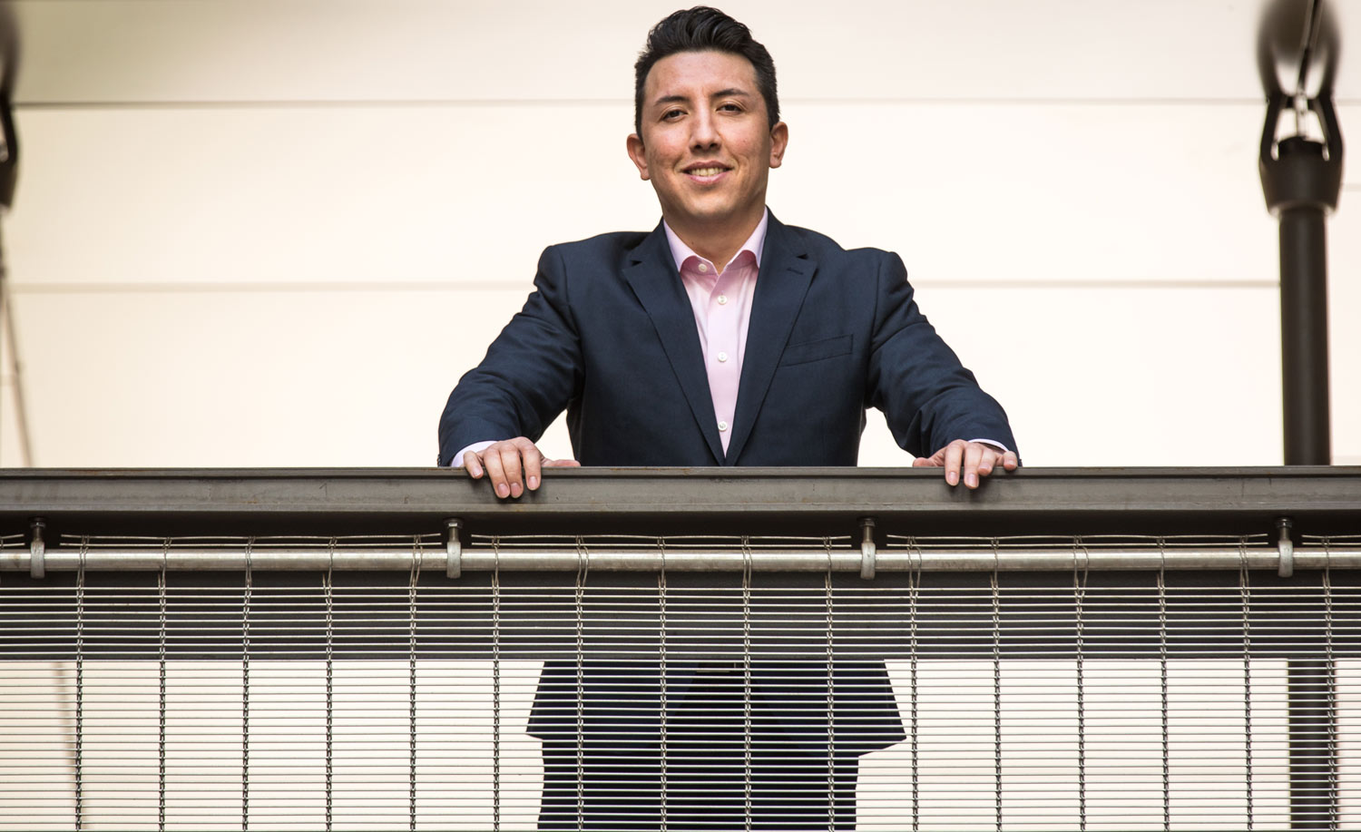 A graduate of the master’s in legal studies with an emphasis in conflict resolution program sits at a desk.